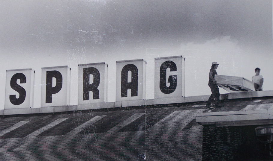 Workers take down 'Sprague' sign from atop mill