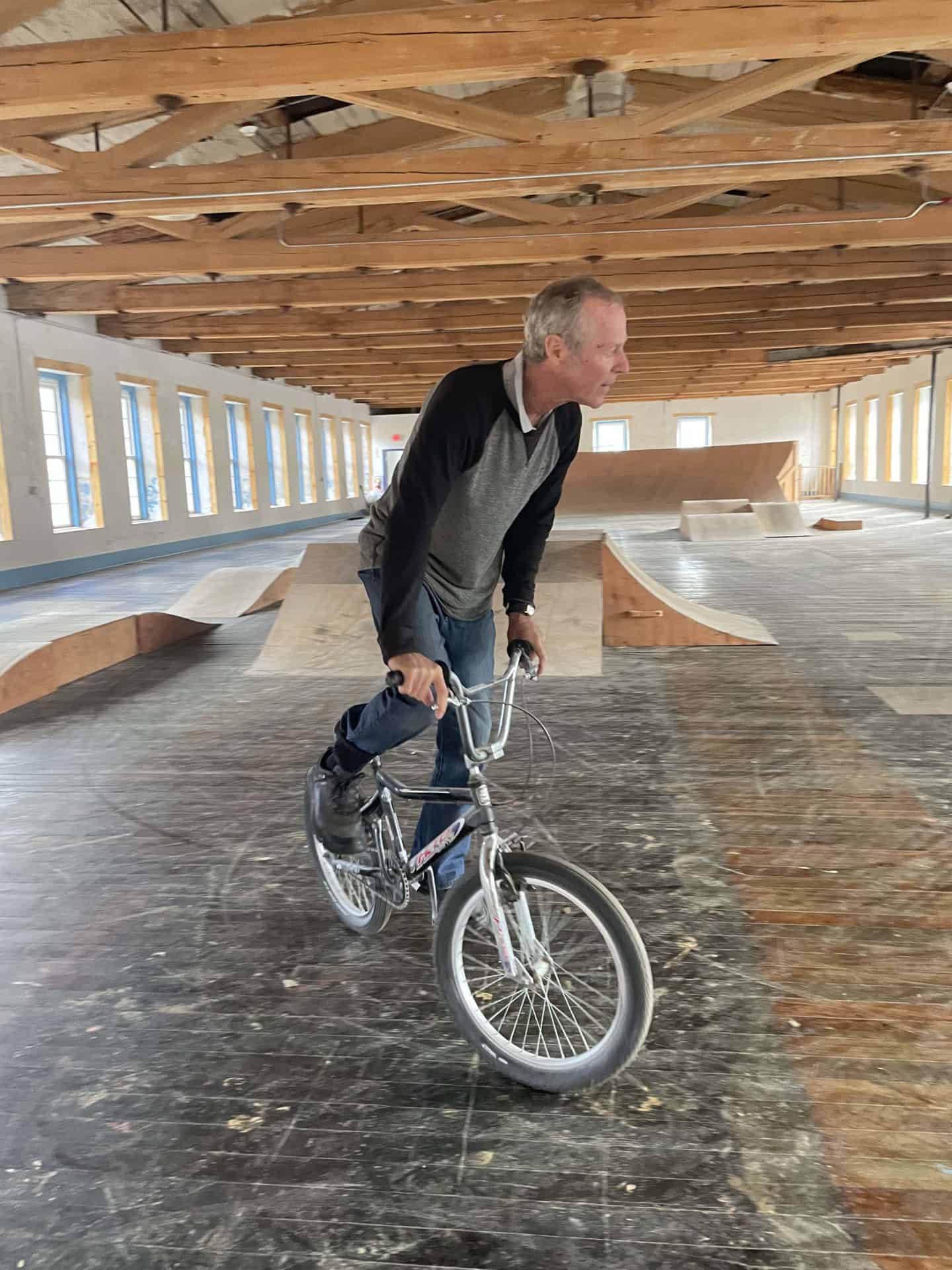 Michael Augsourger rides a bike though an indoor course at the Old Stone Mill in Adams.