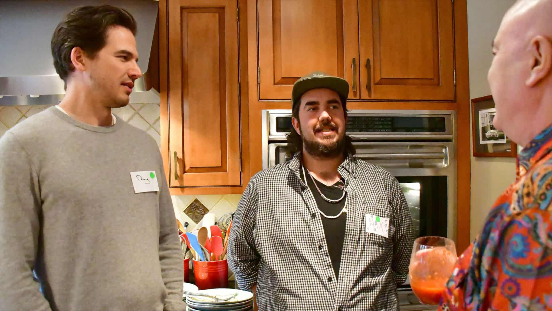 From left, Doug Williams, Max Rivinus and Gregg Farnam share conversation in the kitchen during a potluck in Sheffield for 