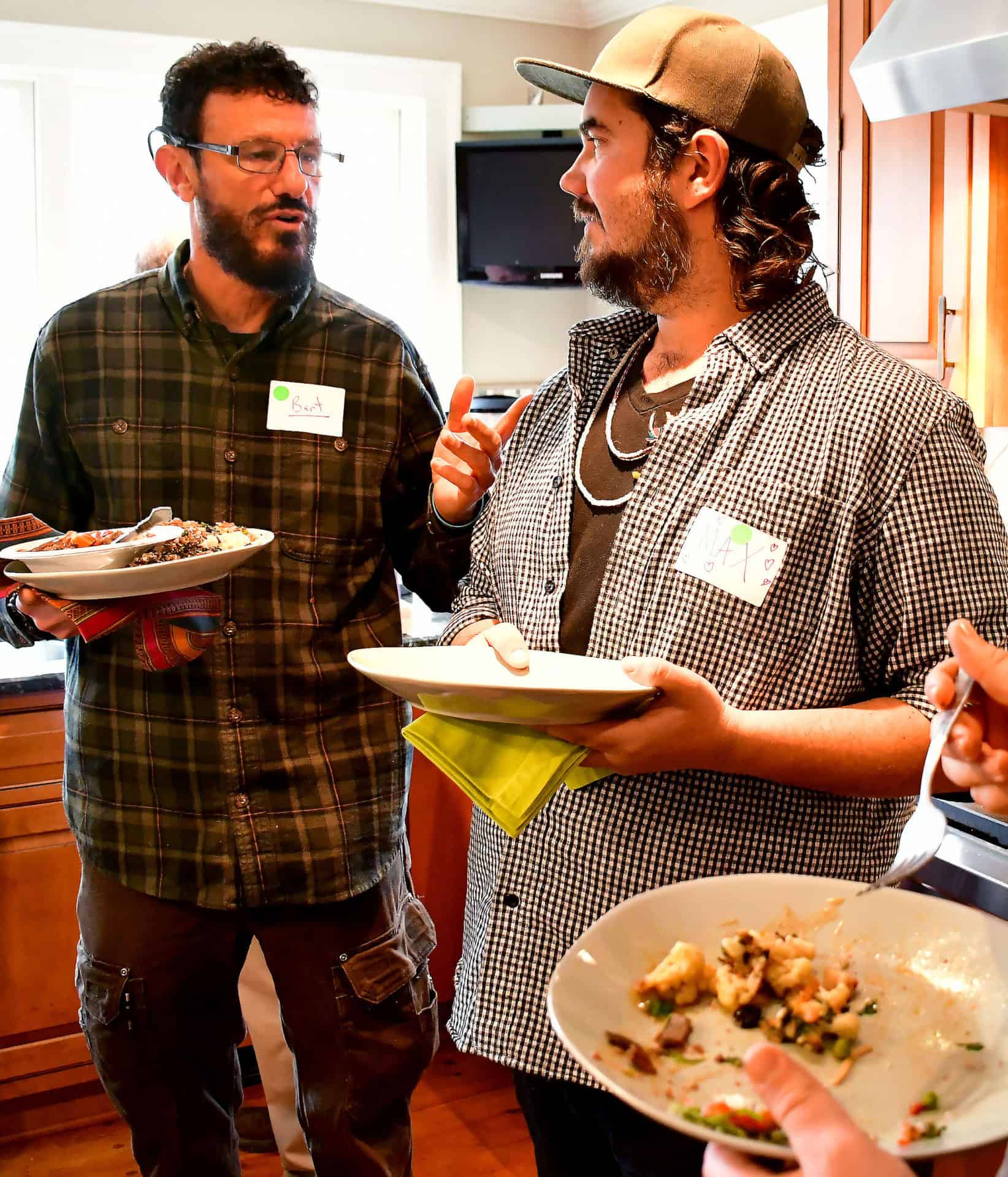 From left, Bart Church, Max Rivinus and Ryan Stufano share conversation during a potluck in Sheffield for 