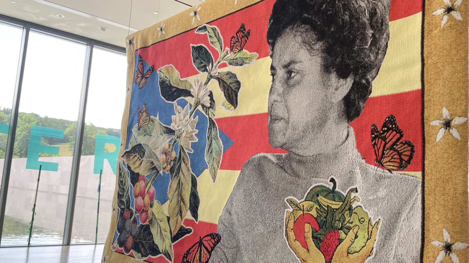 Faustina “Tinti” Deyá Díaz (1940–2021), an environmental activist in Puerto Rico, stands among blooming coffee flowers in Carolina Cayedo's 'We save our seeds for the following season' at the Clark Art Institute.