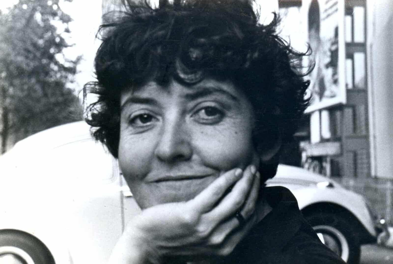 Maria Irene Fornés rests her chin on her hand, smiling with wry mischief in a black and white photo in the 1970s. Photo by and courtesy of Marcella Matarese Scuderi and Michelle Memran and The Rest I Make Up