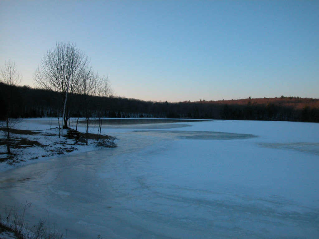 Sunset glimmers in Pomfret, Conn., over a frozen pond.