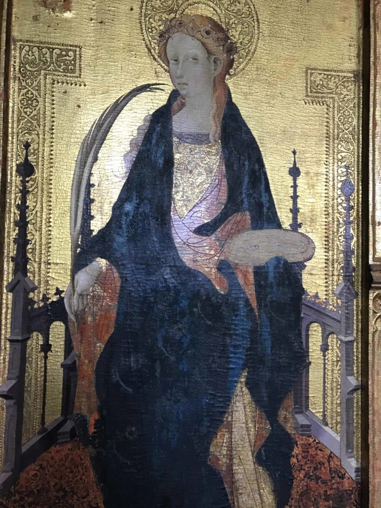 St. Lucy catches sunlight on a gilded background at the Williams College Museum of Art (WCMA).