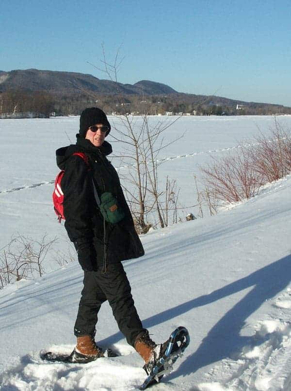 Thom Smith's wife, Susan, snowshoes along the rail trail on a bright winter afternoon.
