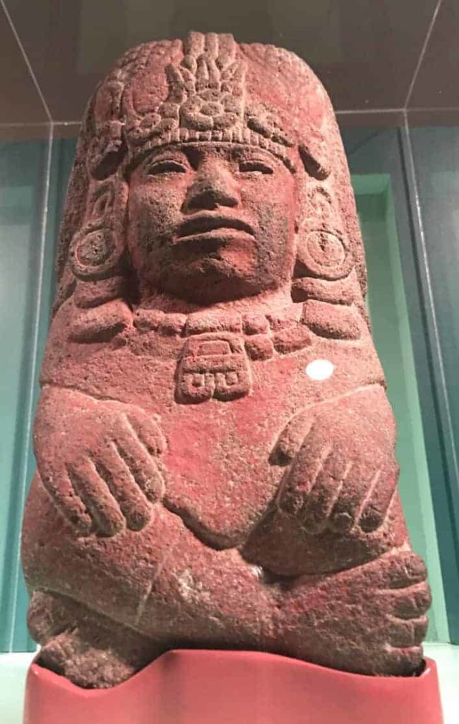 An Aztec fertility goddess looks down from a pillar at the center of Seeds of Divinity at WCMA. On load from the Worceser Art Museum. Photo by Kate Abbott