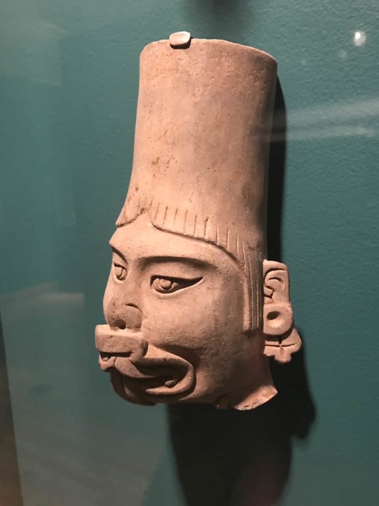 A Zapotec figure wears a supernatural face mask. It was made in Oaxaca c. 100 CE. On loan from the Worcester Art Museum. Photo by Kate Abbott