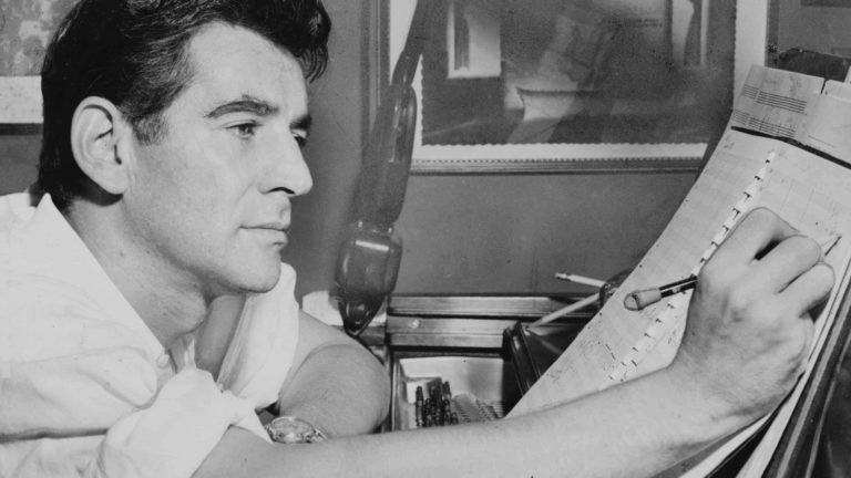 Leonard Bernstein, who conducted packed concerts at Tanglewood in Lenox for most of his life, works on a musical score at his desk.