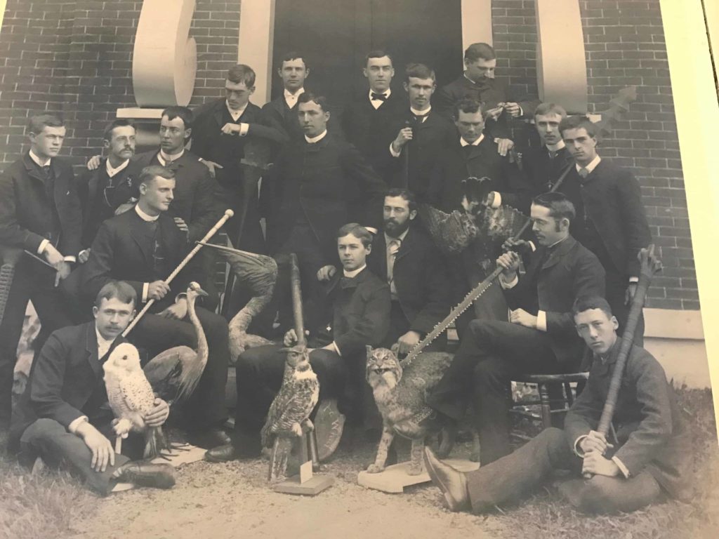 Students in the Lyceum at William college in the 19th century pose with artifacts from their collection. Image in The Field Is the World at the Williams College Museum of Art.
