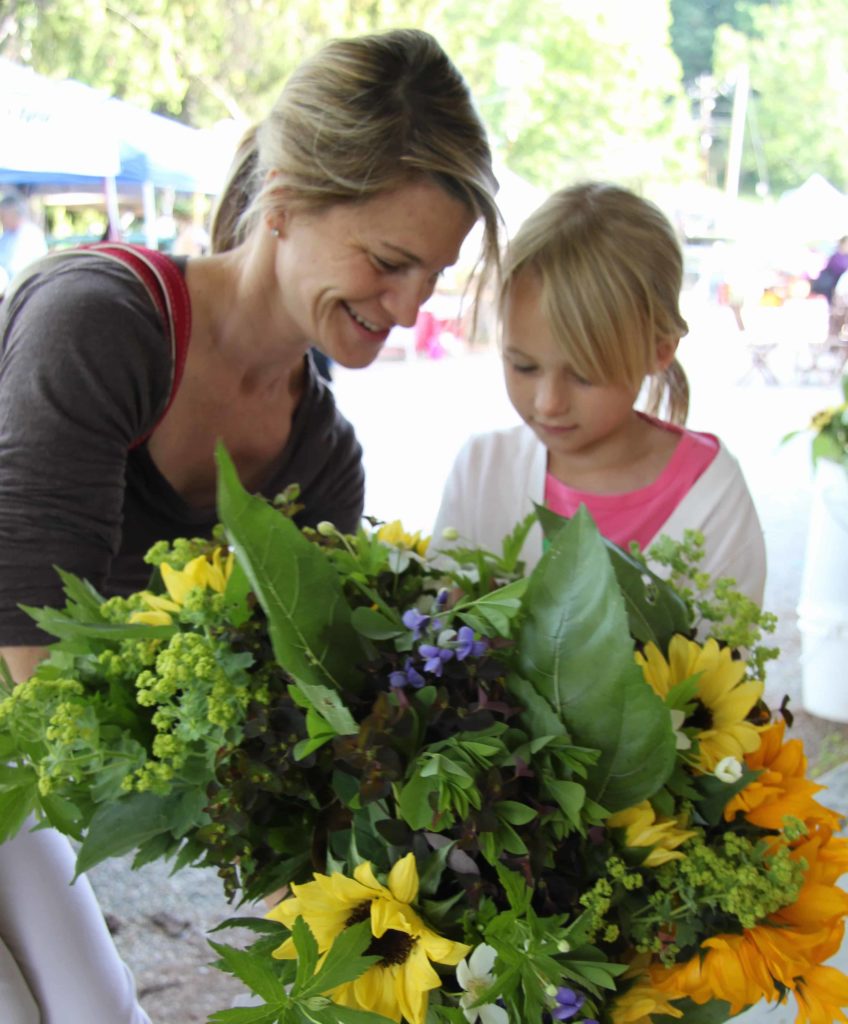 Visitors choose a bouquet of locally grown flowers at the Great Barrington Farmers Market.