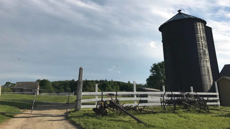 Historic siloes stand near the Round Stone Barn at Hancock Shaker Village. Photo by Kate Abbott
