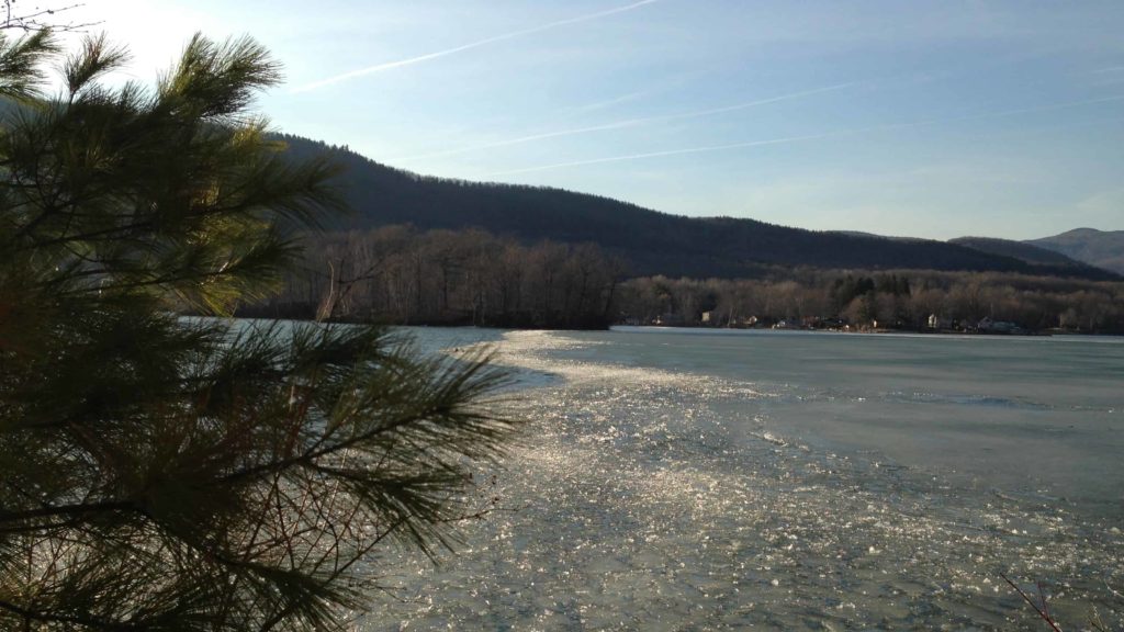 Ice breaks up on Cheshire Lake, seen from the the Ashuwillticook Rail Trail on a sunny day in February.