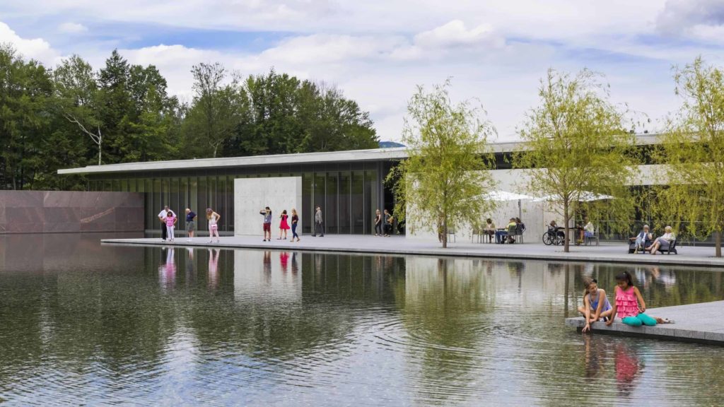 Visitors sit in the sun by the reflecting pool designed by Tadao Ando at the Clark Art Institute in Williamstown.