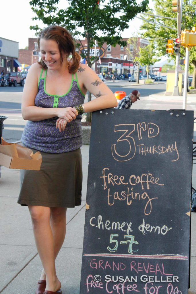 Jess Lamb, owner of Dottie's Coffee Lounge, enjoys a warm day oby her coffee shop n North Street in Pittsfield.