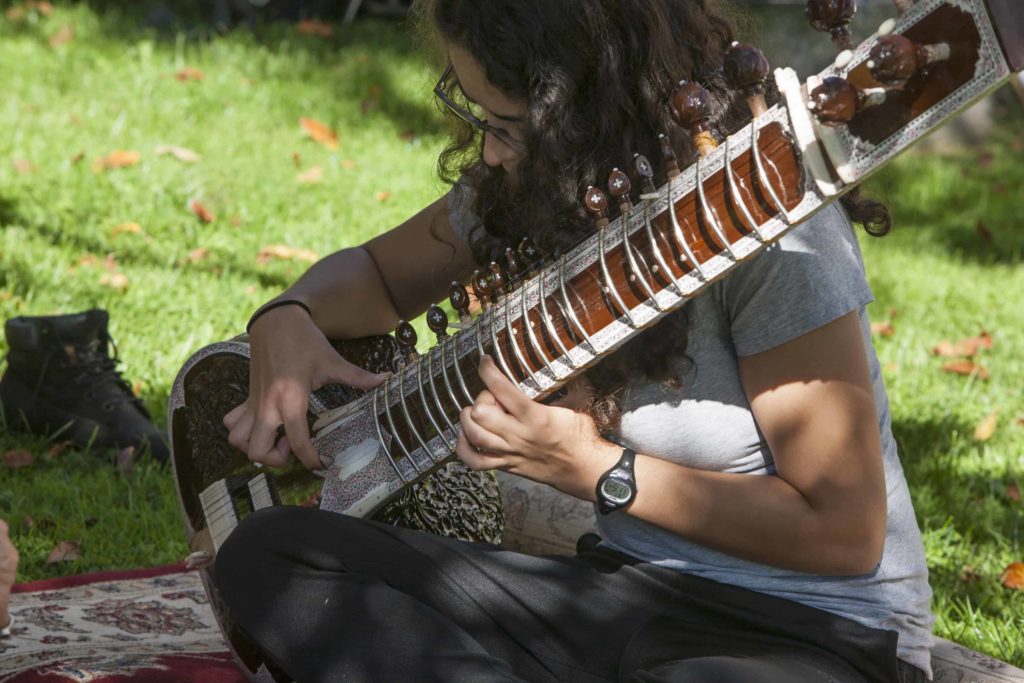 A student performs outdoors on Mountain Day at Williams College. Students celebrate a fall day with music and outdoor activities.