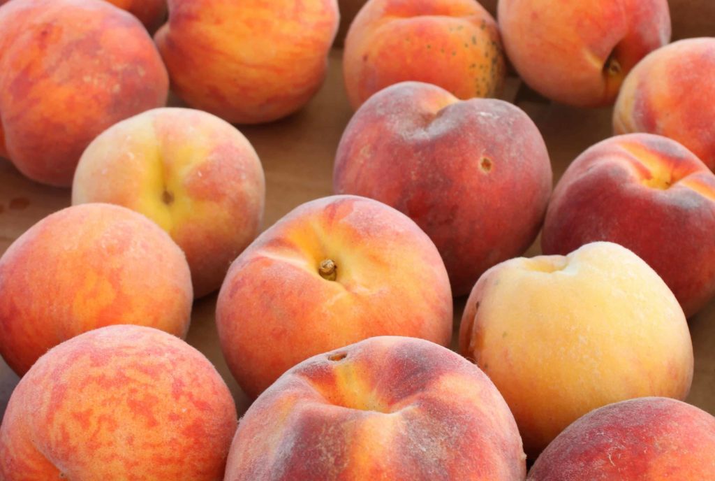 Peaches hold a warm glow of August at the Pittsfield Farmers Market.