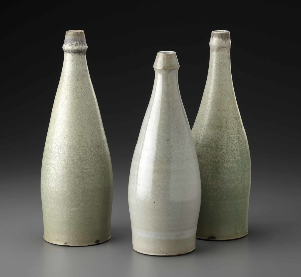 Tall, creamy bottles by ceramics artist Michael McCarthy.
