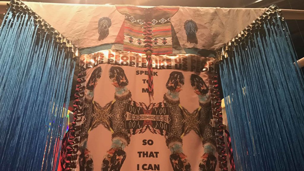 Cherokee and Choctaw artist Jeffrey Gibson's fiber art honors his heritage and his experiences as a young, gay Native American, in Suffering from Realness at Mass MoCA.