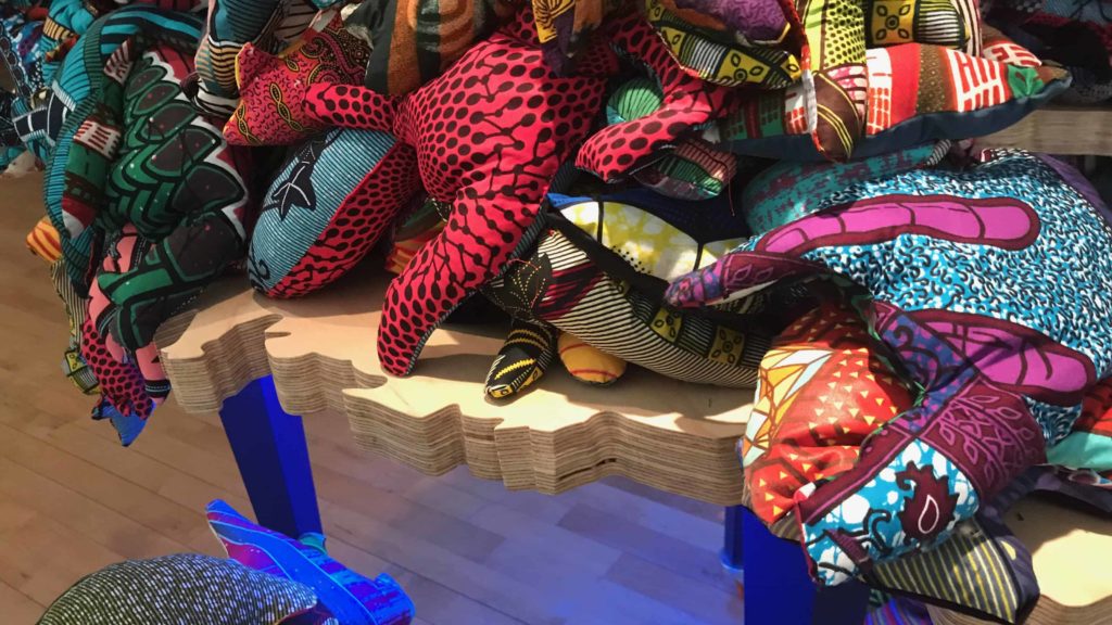 Organic forms in bean-bag shapes are made from bright fabric that recalls Kente cloth and African patterns, in Cauleen Smith's retrospective, 'We Already Have what We Need,' at Mass MoCA.