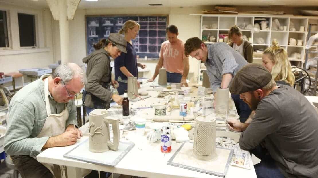 Amateur potters shape clay at an Arts Night Out event in the studios at IS183.