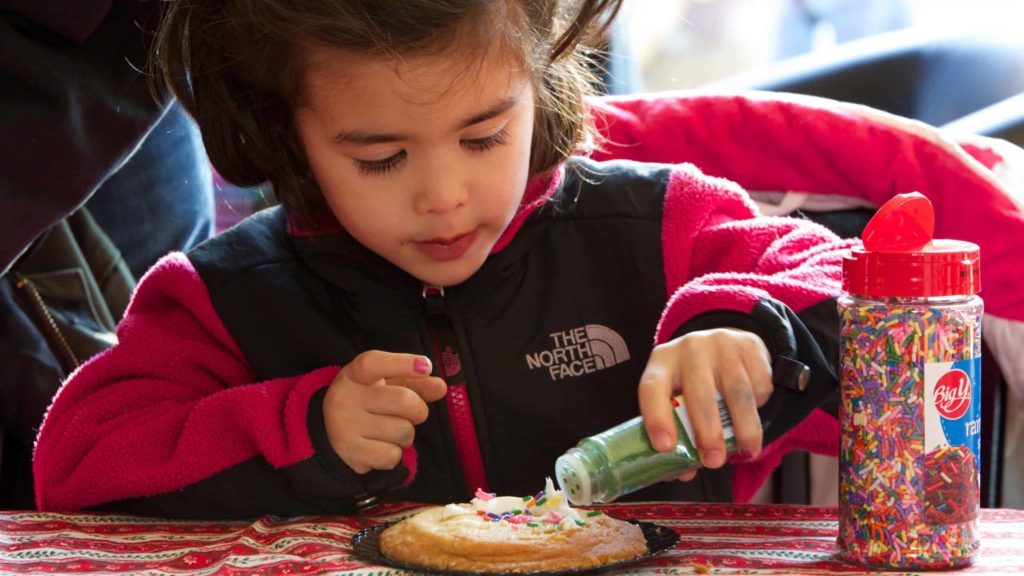 A young visitor decorates a cookie at the annual Williamstown Holiday Walk.