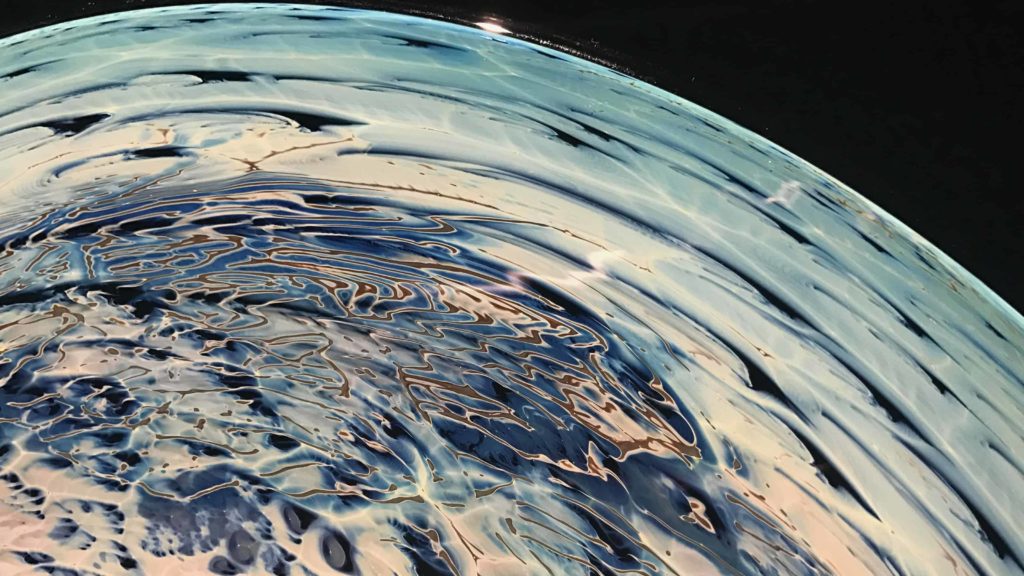 A planet by Glass artist Josh Simpson ripples in the light at the Berkshire Museum in summer 2018.