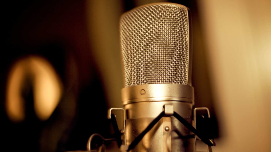 A microphone waits in golden light. Creative Commons courtesy photo.