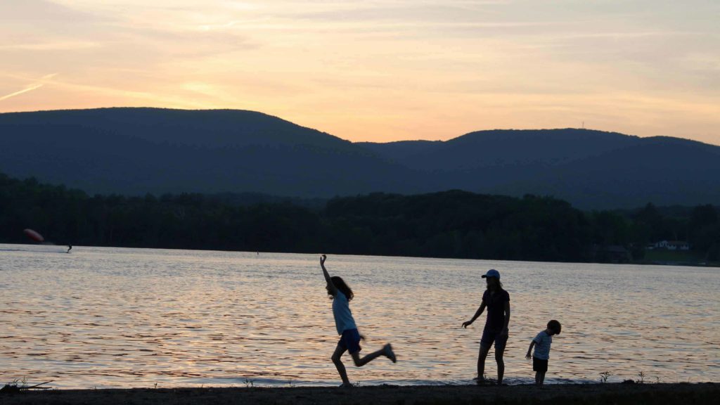 A family runs along the shore at Onota Lake in Pittsfield.