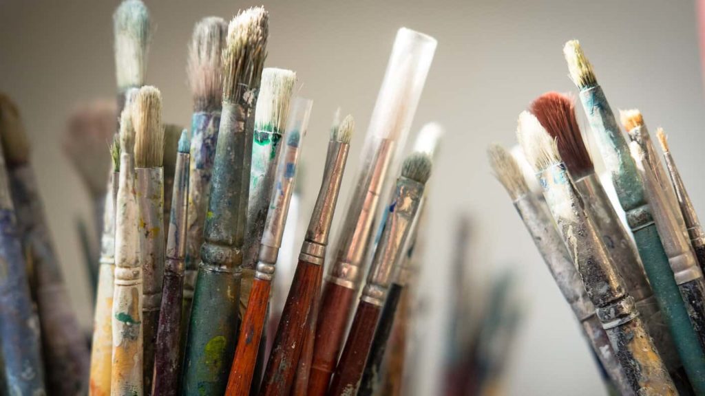 Paint brushes lean in cups, waiting for color. Press photo courtesy of IS183 Art School.