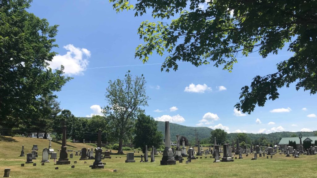 From the sweep of where W.E.B. DuBois' first wife and son and daughter lie buried, the cemetery stretches toward the hills south of Great Barrington.