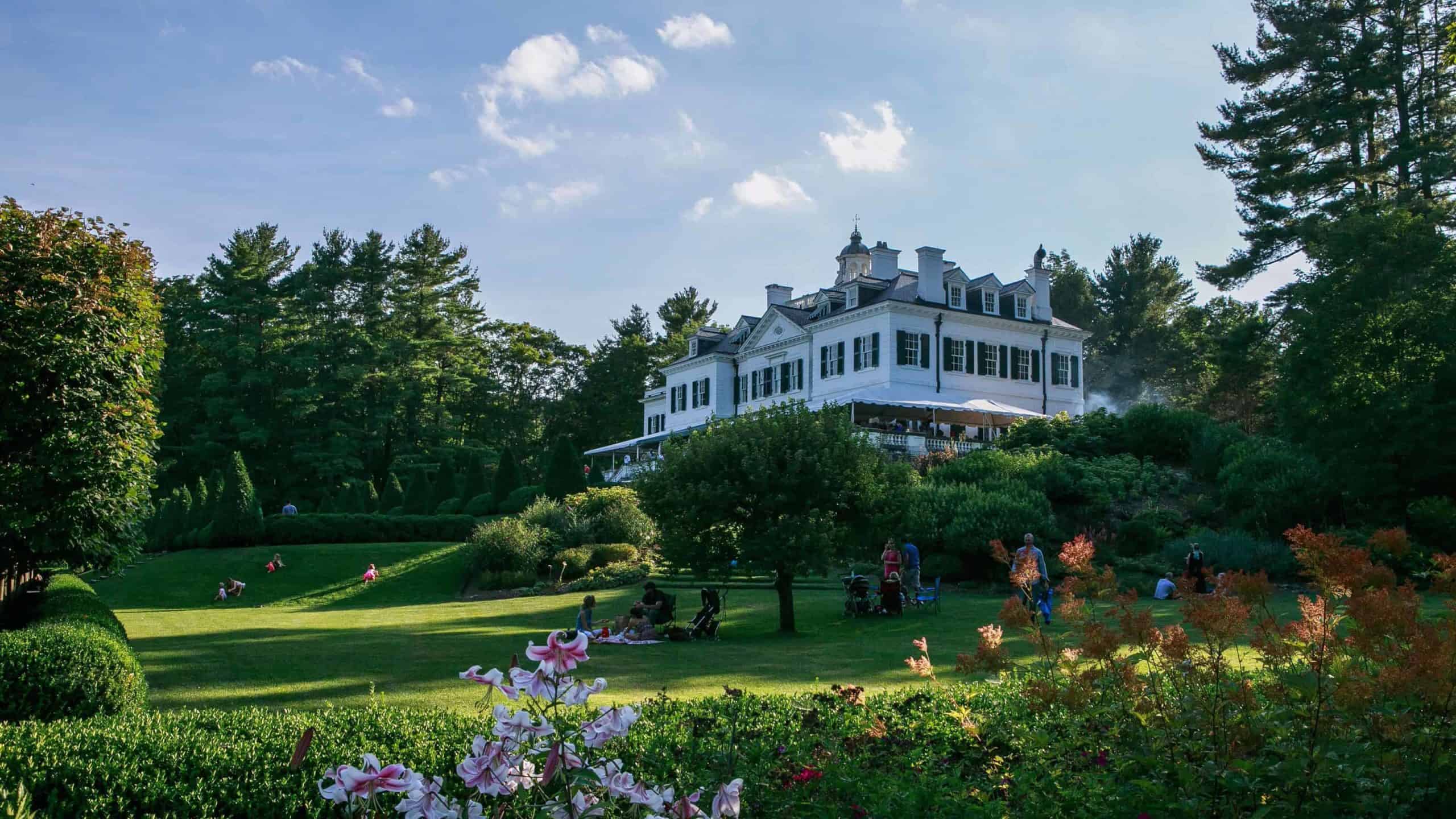 Families picnic on the lawn on a summer evening at the Mount, Edith Wharton's historic house in Lenox.