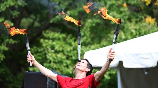 An entertainer juggles torches at the Berkshire Botanical Garden's fall harvest festival.