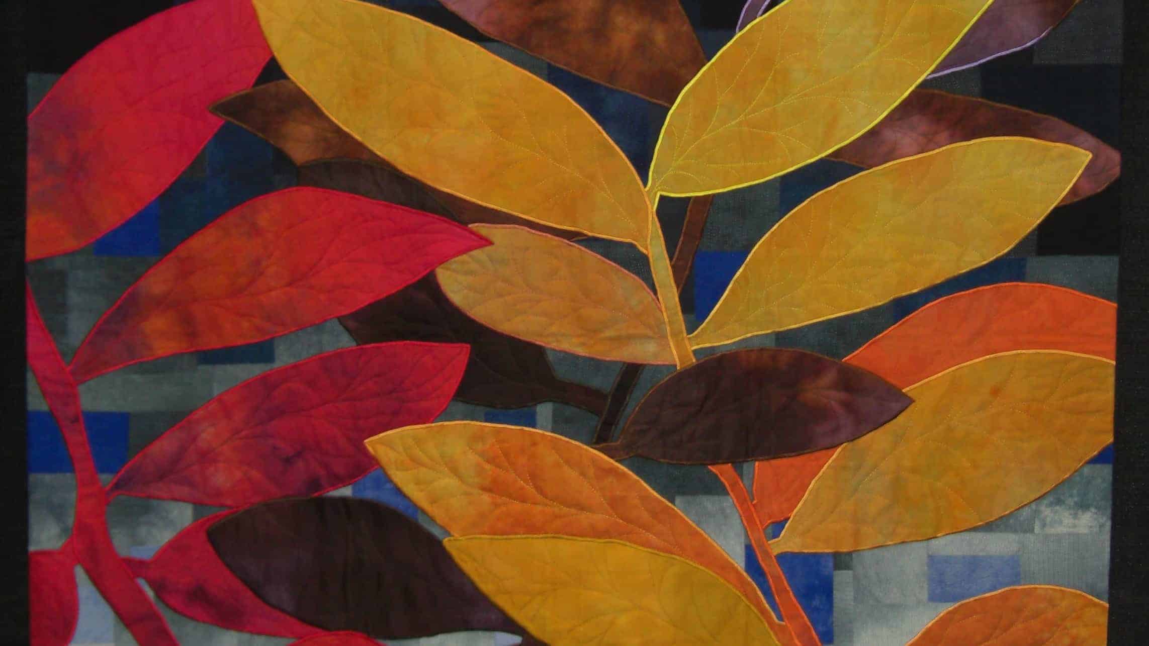 A quilt flames in autumn colors at the Mid Atlantic Quilt Festival.