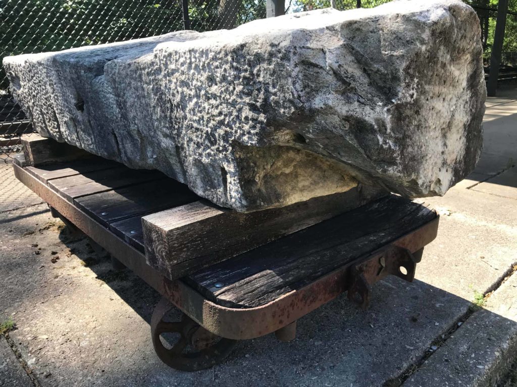 A block of Berkshire marble sits on a hand cart near the railroad tracks in Great Barrington, recalling the town's industrial past.