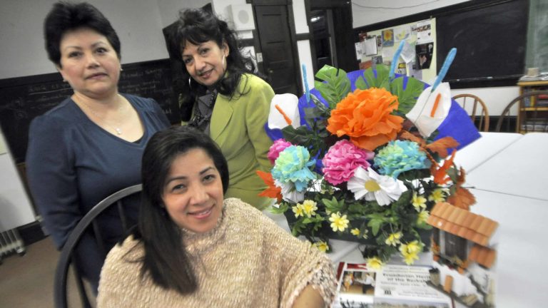 Patricia Cambi, seated, Maria Soria, standing at left, and Rocio Chavez share memories from their childhood homes. Photo runs here with permission from the Berkshire Eagle.