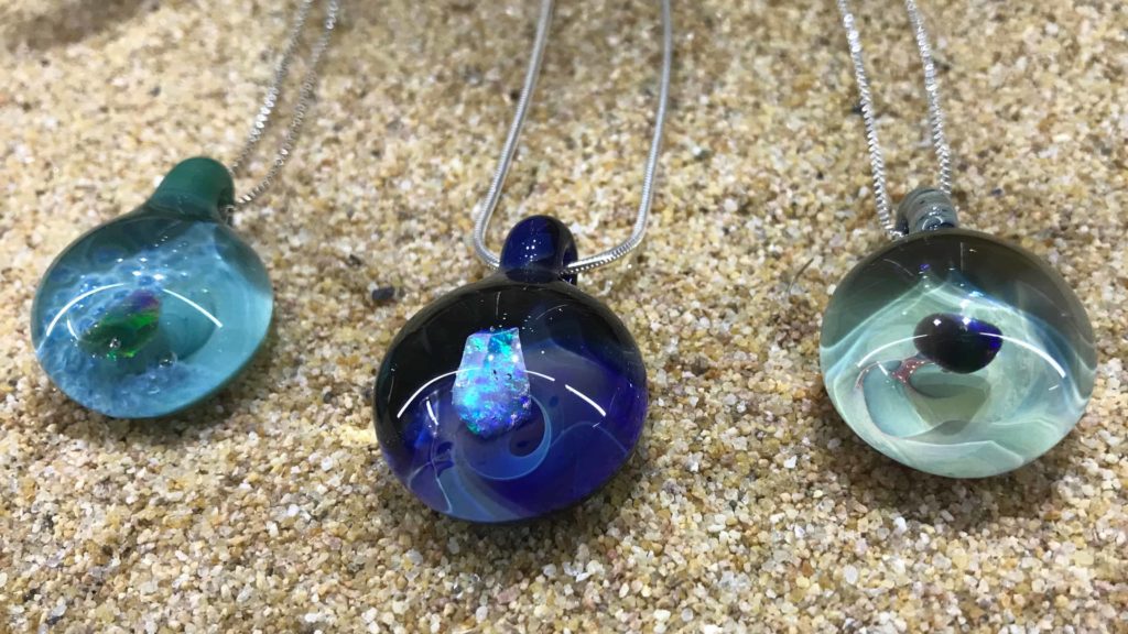 Pendants gleam clear and bluegreen at at Cheshire Glassworks.