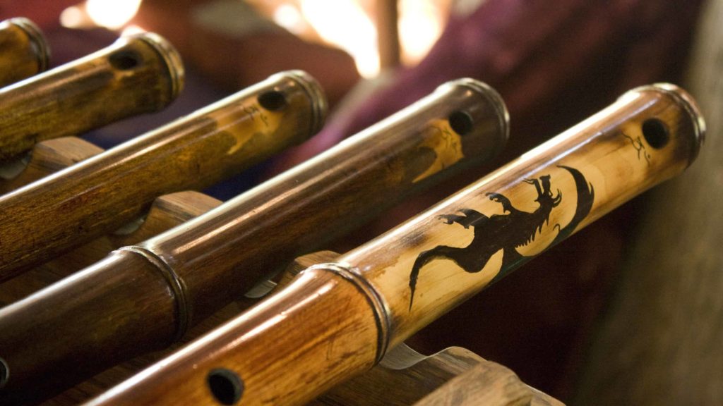 Hand-carved wooden flutes rest side by side. Creative Commons cuortesy photo