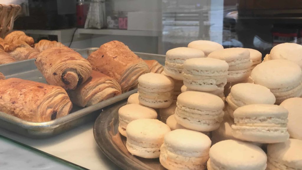 Filled croissants and macarons sit in a warm light at the Lost Lamb bakery and cafe in Stockbridge.