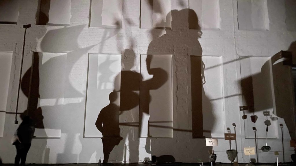 Shadow figures move across the long walls of Gallery 5 in Glenn Kaino's new work at Mass MoCA.
