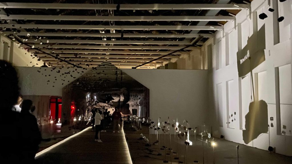 Light and shadow flows alongside a long central walkway in Glenn Kaino's new work at Mass MoCA.