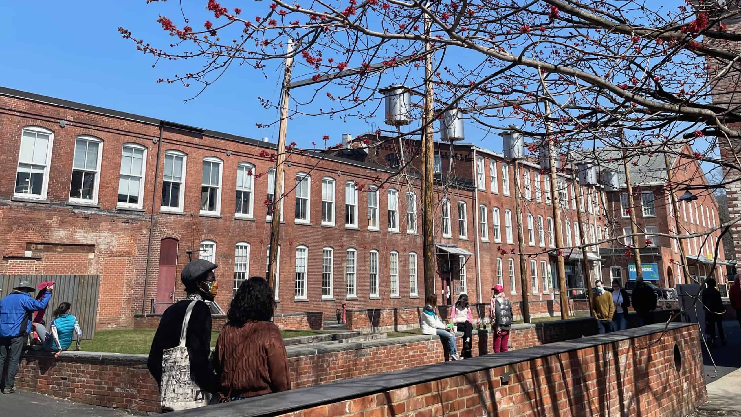 Visitors cross the courtyard at Mass MoCA in early spring.