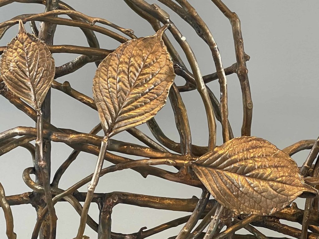 Bronze and gold leaves twine around a bench by sculptor Claude Lalanne in Nature Transformed at the Clark Art Institute.