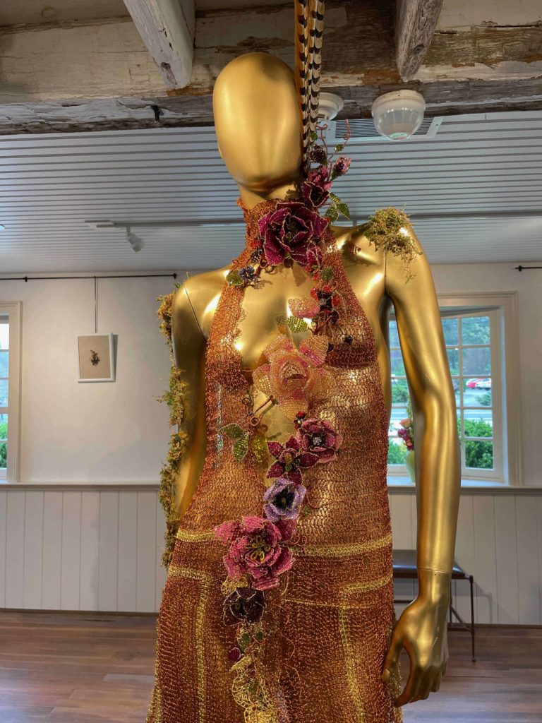 Mindy Lam brightens a gown f her signature metal lace with beaded blossoms of her jewelry art in Flights of Fancy at the Berkshire Botanical Garden.
