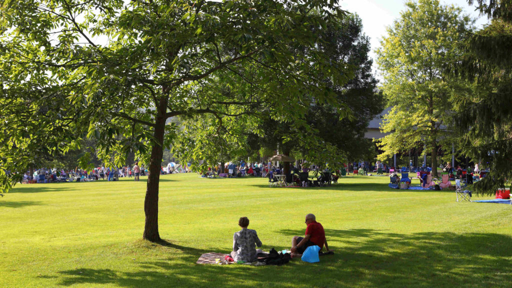 A family rests in the shade on the Tanglewood lawn. Press photo courtesy of the BSO.