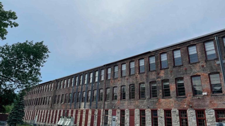 The windows of Mass MoCA's former mill buildings glint in the sun.