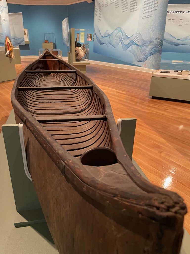 A wooden canoe rests at the center of Mu-he-con-ne-ok, the Mohican people, people of the waters that are never still, an exhibit curated by Heather Breugl, director of cultural affairs for the Stockbridge Munsee community of the Mohican nation, at the Berkshire Museum.