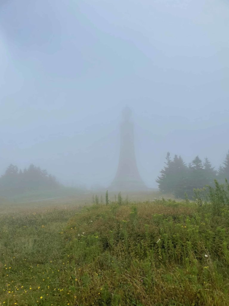 The lighthouse — now a World War I memorial — stands almost invisible in the fog on a rainy day at the summit of Mount Greylock.