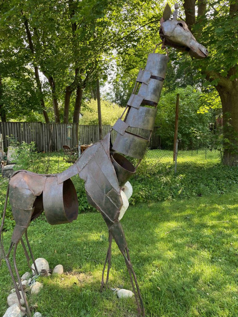 A steel giraffe by Harlan Mac stands in the park across from the Vermont Arts Exchange in the North Bennington Outdoor Sculpture Show.