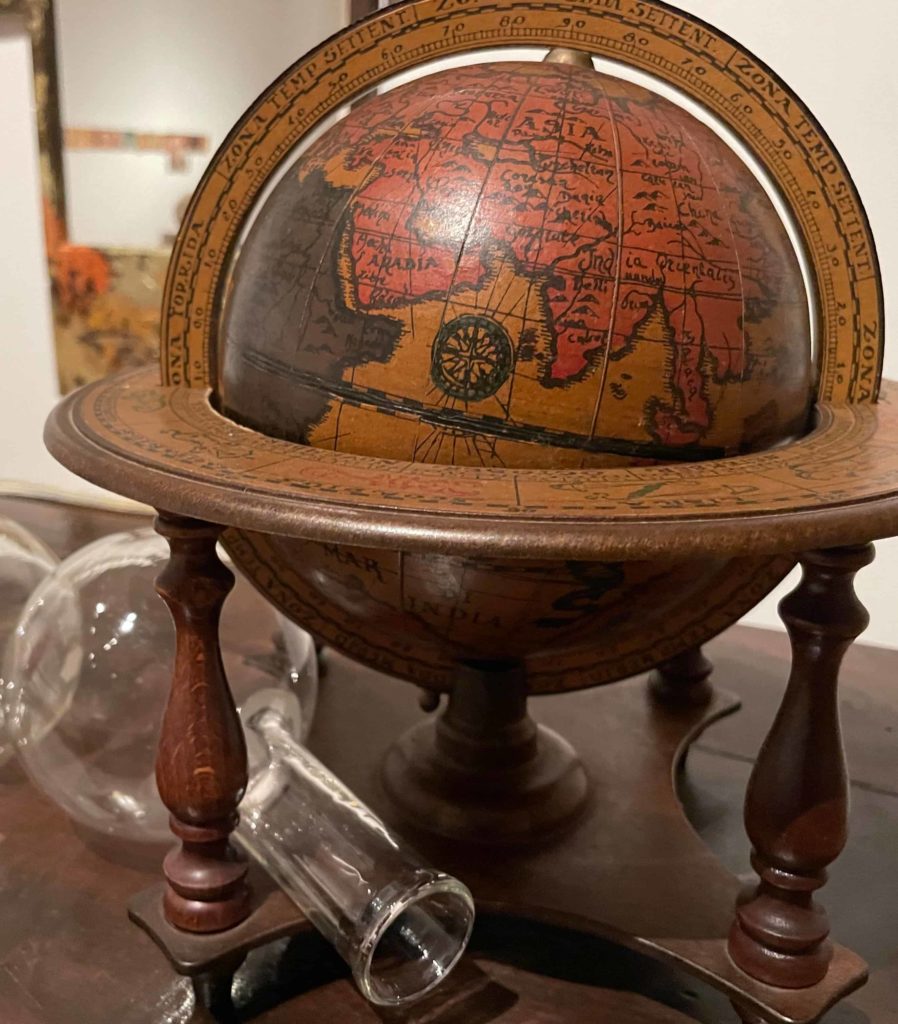 A globe shows countries near the Arabian sea in a closeup from Amalia Mesa-Bains' installation, The Library of Sor Juana Inez de la Cruz at WCMA