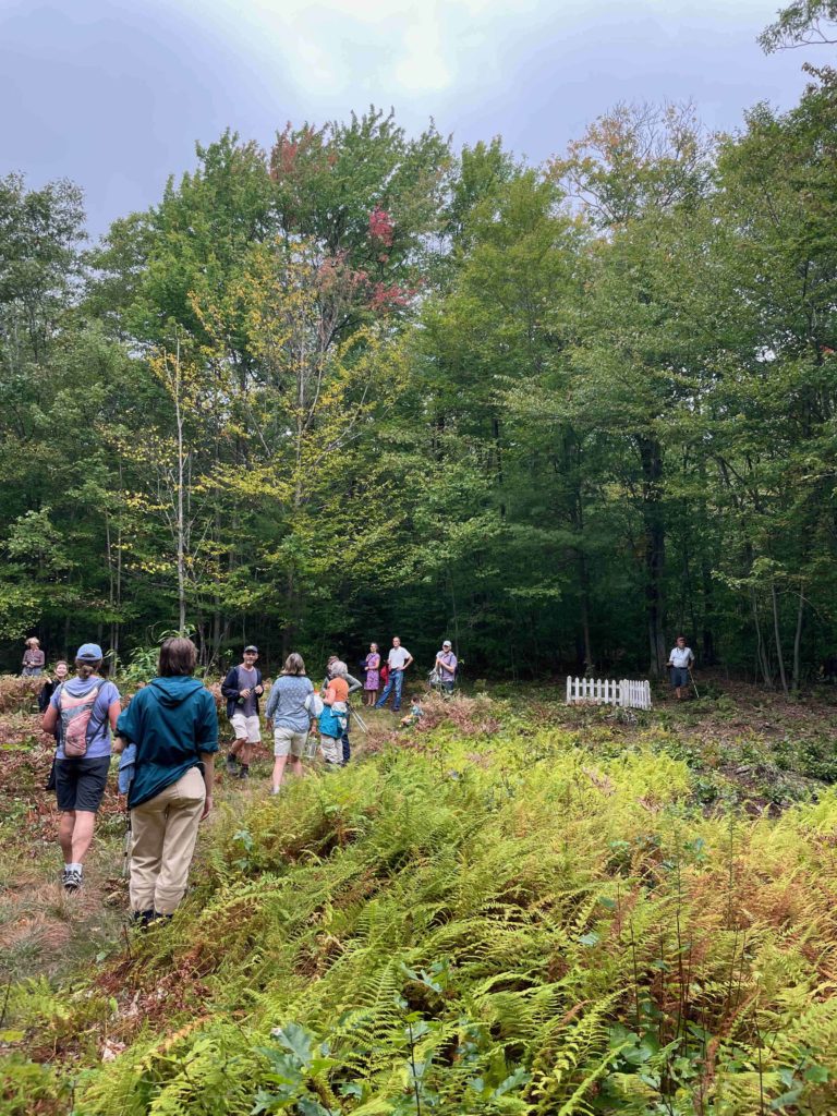 Walkers gather in the high meadow at the opening of Climbing Holy Hill at Hancock Shaker Village.